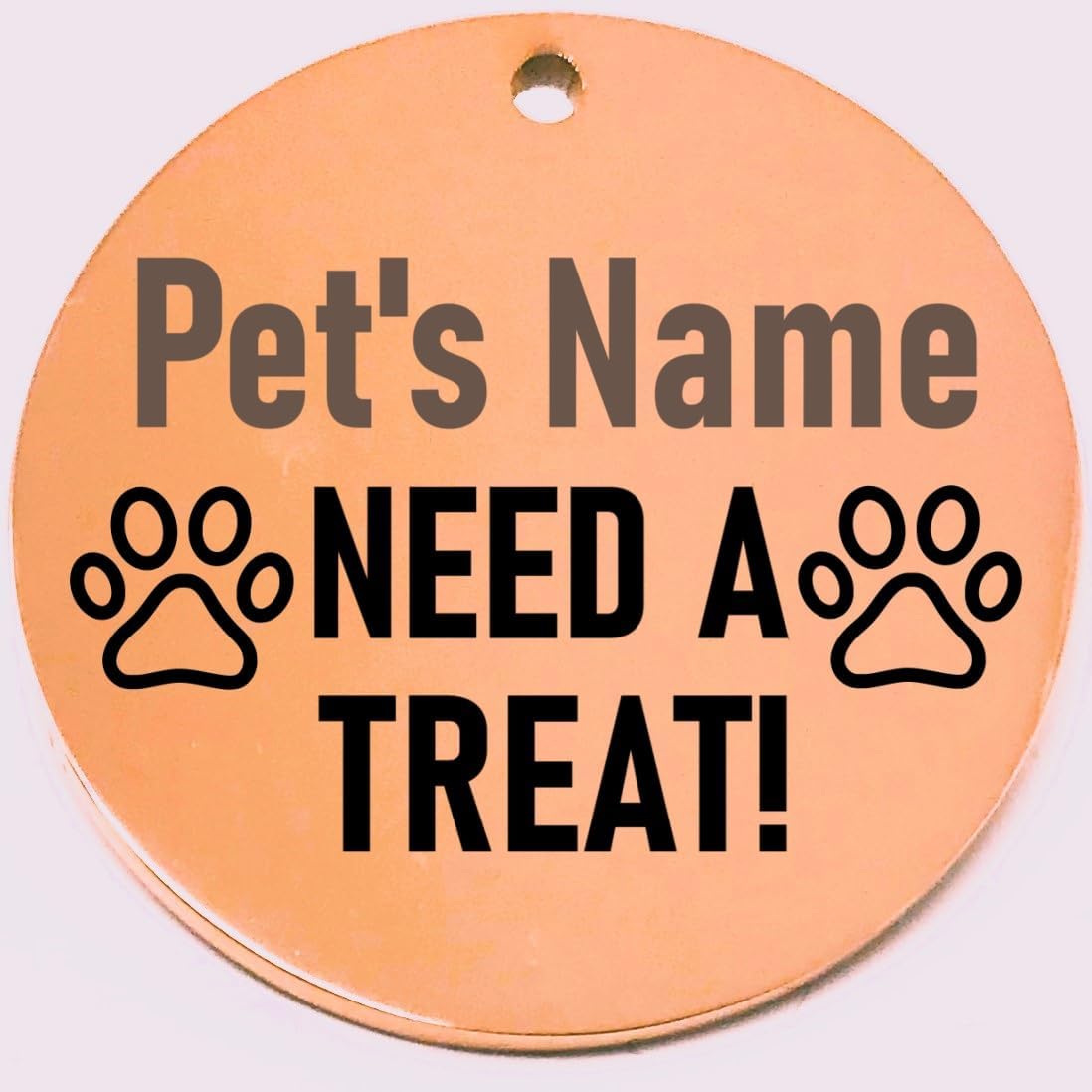 Round pet name tag with 'Pet's Name NEED A TREAT!' text on a rose gold background