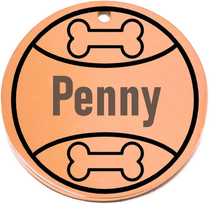 Personalized round pet id tag with 'Penny' engraved, surrounded by bone designs on a white background