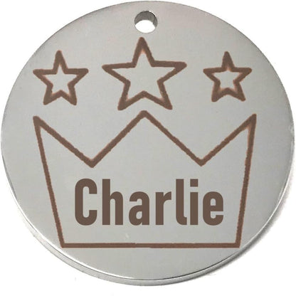 Round silver pet name tag with star design and 'Charlie' engraving on a white background