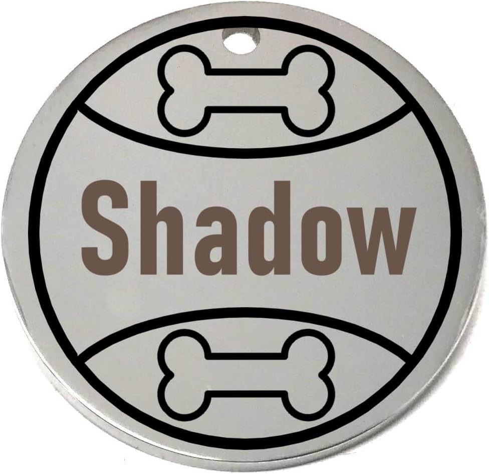 Round silver pet tag with 'Shadow' engraved and bone designs on a white background