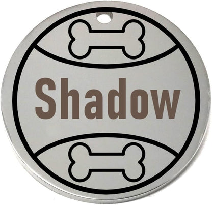 Round silver pet tag with 'Shadow' engraved and bone designs on a white background
